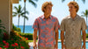 Two men standing outdoors wearing Aloha shirts with palm trees and ocean in the background